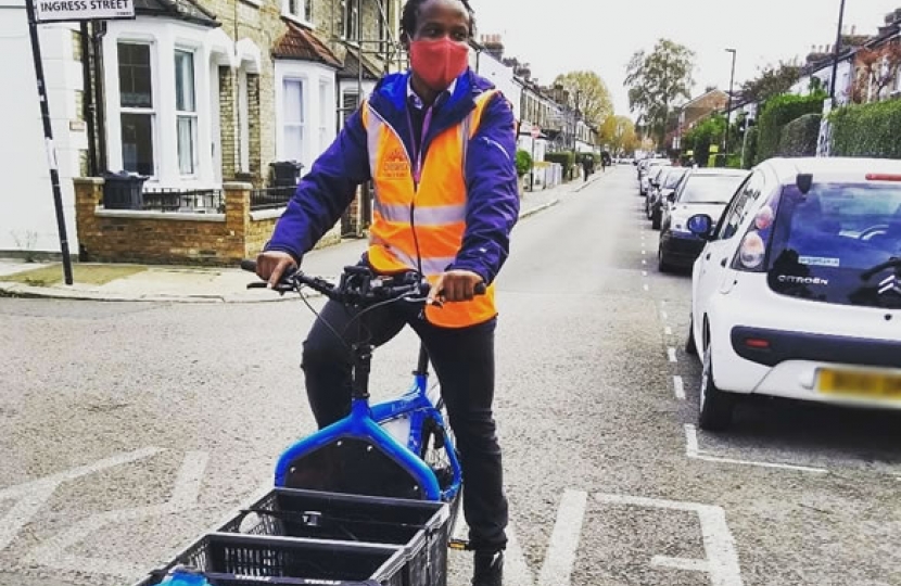 Turnham Green councillor Ron Mushiso making a delivery